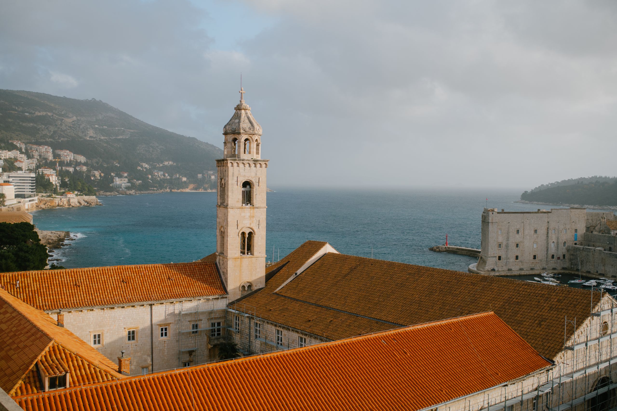 Limestone-paved Stradun at dusk with the Bell Tower ahead
